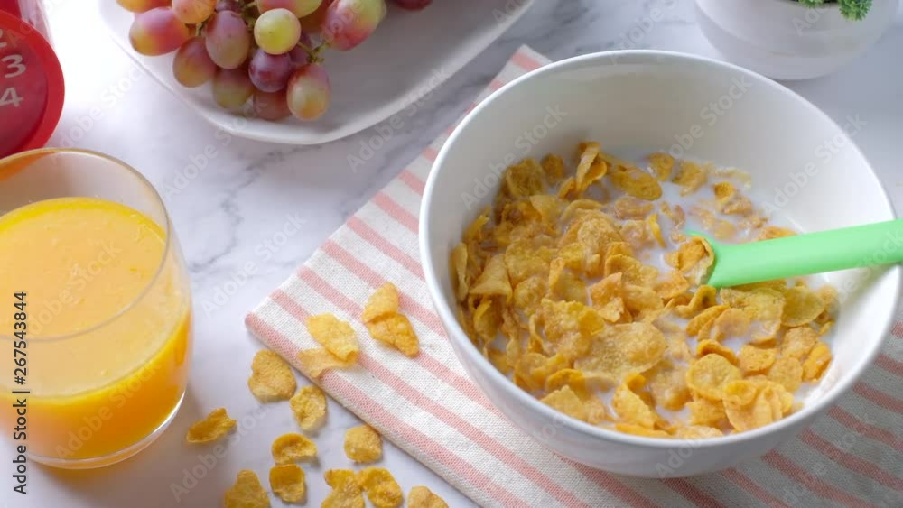Slider Shot of cereal, orange juice, grape and fresh milk on marble desk in morning Slider Shot of cereal, orange juice, grape and fresh milk on marble desk in morning