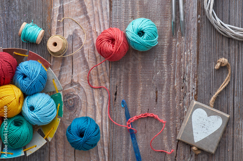 Crochet, top view on yarn balls on wood