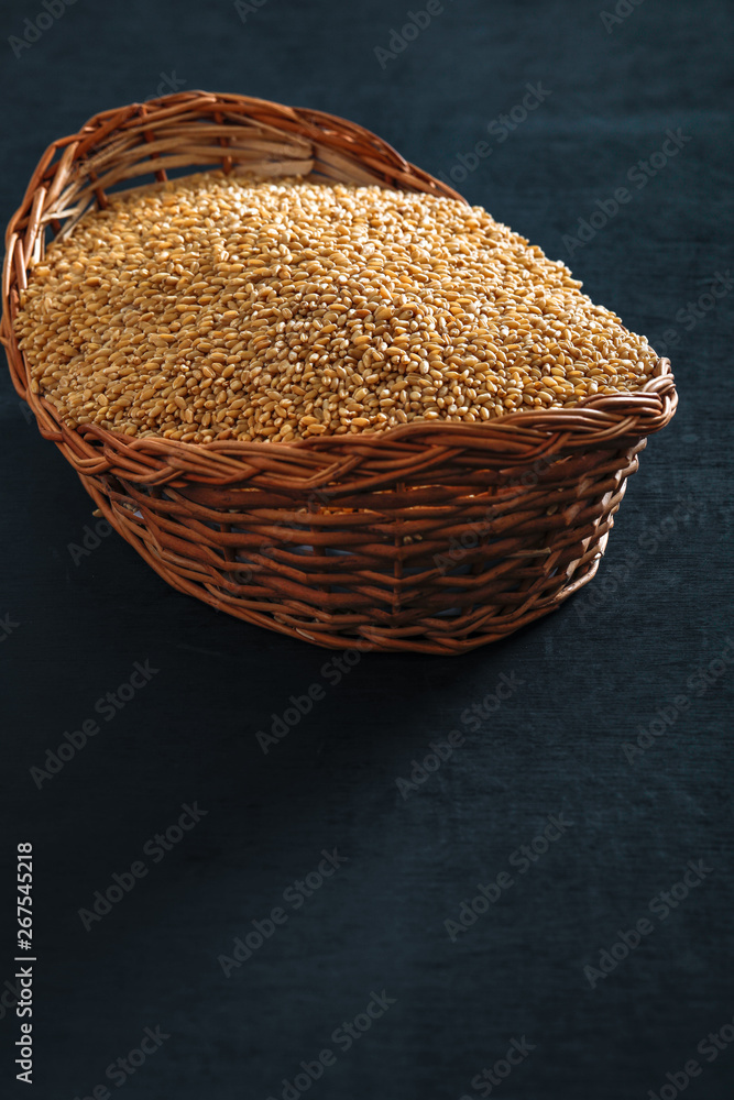  wheat in wooden bowl on wooden background