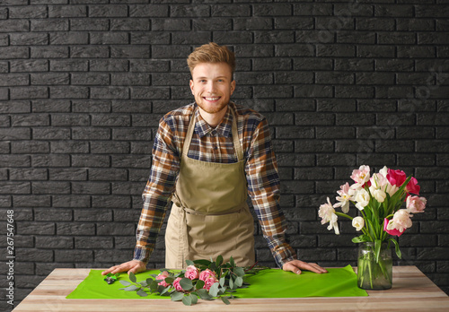 Handsome florist at table a...