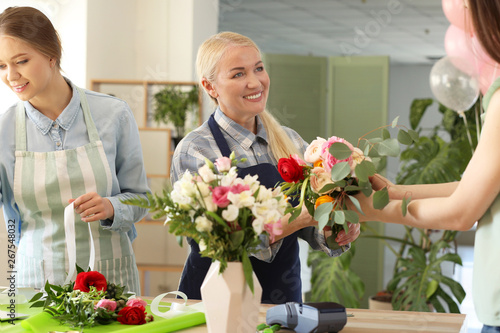 Customer buying flowers in ...