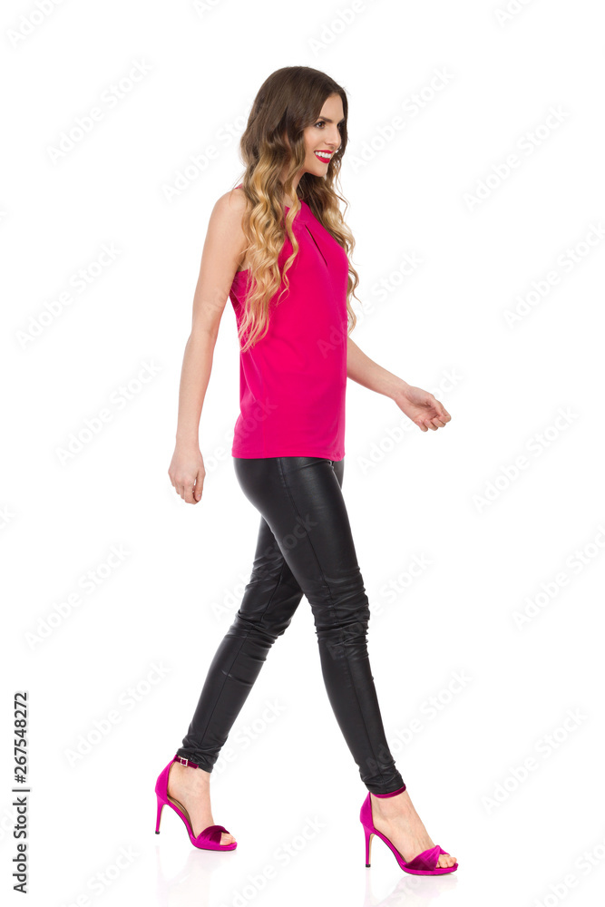 Smiling Beautiful Woman Is Walking In Pink High Heels. Side View Smiling Beautiful Woman Is Walking In Pink High Heels. Side View