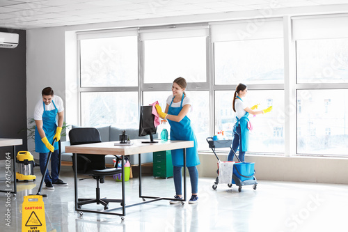 Team of janitors cleaning o...