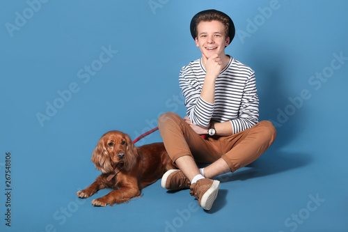 Teenage boy with cute dog o...