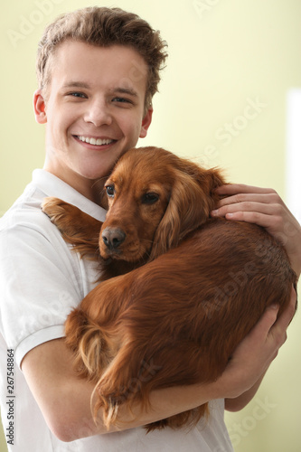 Teenage boy with cute dog o...