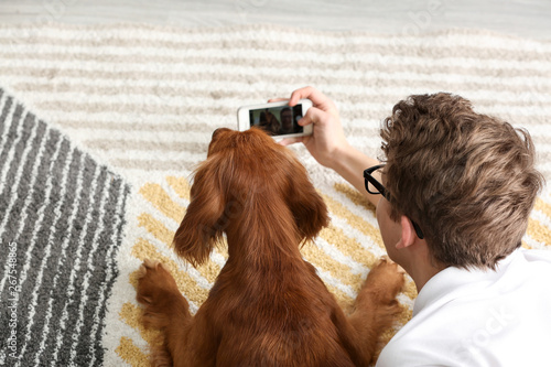 Teenage boy with cute dog t...