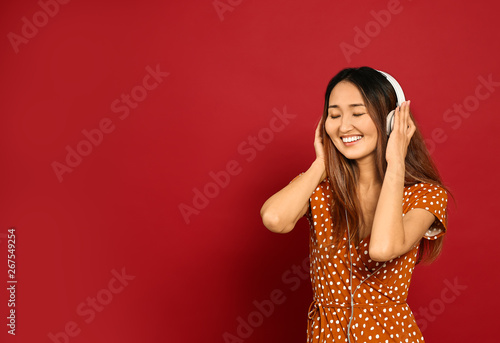 Asian woman listening to mu...