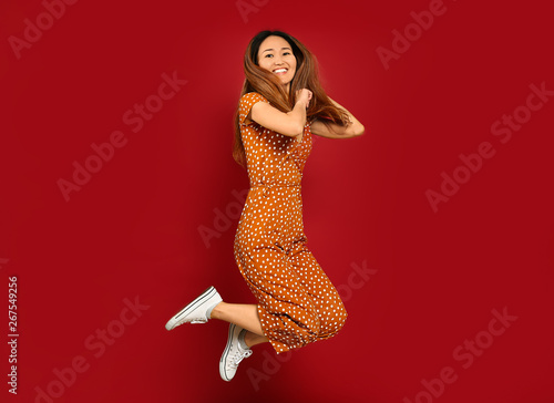 Jumping Asian woman on colo...