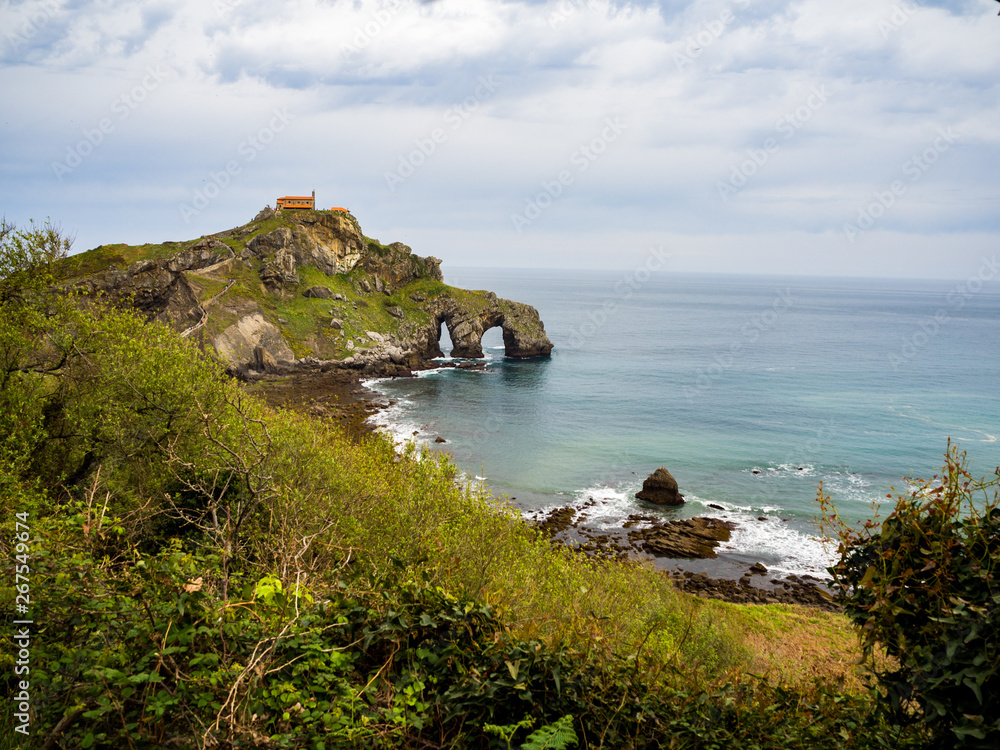 san juan de gaztelugatxe with the blue sea as background