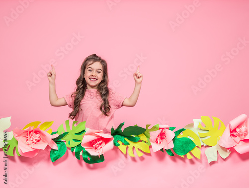 Portrait of a little girl on a summer pink background