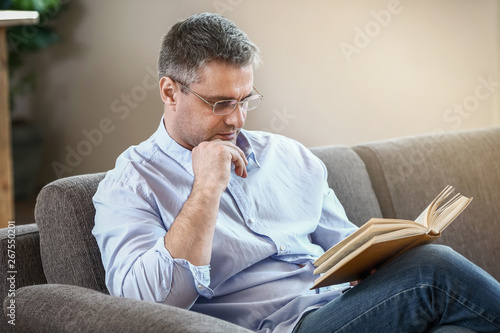 Handsome mature man reading...