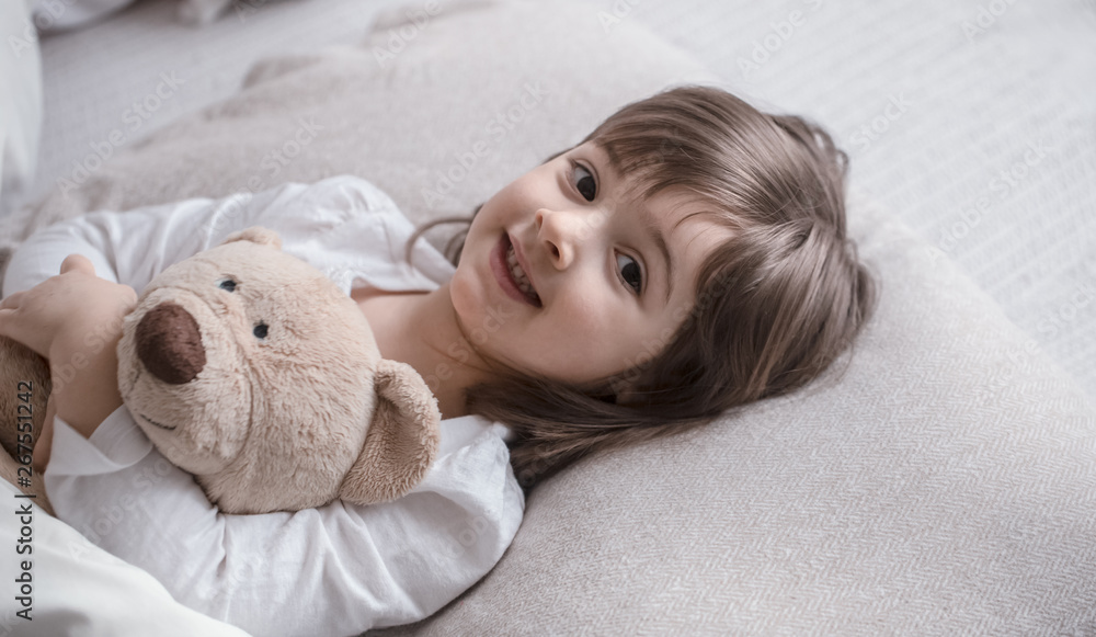 Little cute girl in bed with toy Little cute girl in bed with toy