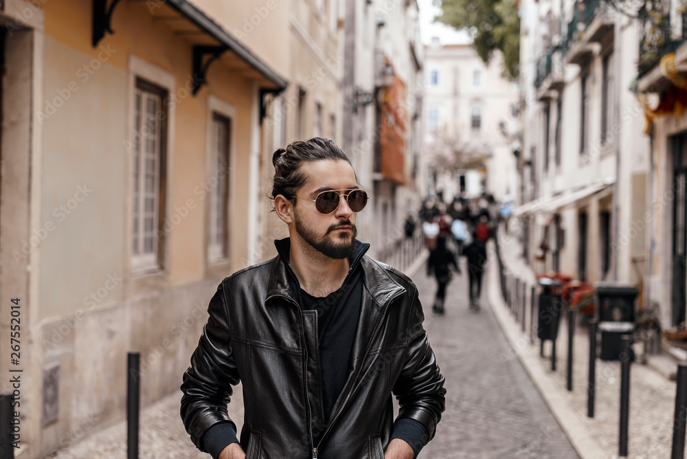 Male with sunglasses posing in alleyway
