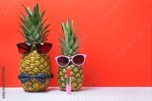 Creative composition with pineapples on color background