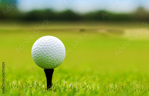 White Golf ball on green course to be shot on blurred beautiful landscape of golf course in bright day time with copy space. Sport, Recreation, Relax in holiday concept 