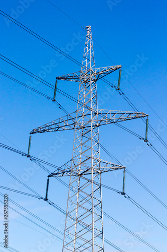 High-voltage electric main against the dark blue sky