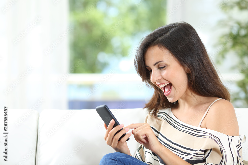 Excited tenant finding offers on phone at home Excited tenant finding offers on phone at home