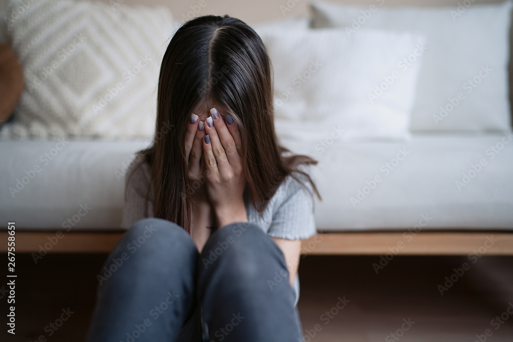 Sad teenager feeling bad alone holding head in hands, feeling depressed, regrets of mistake, having problems, adolescent girl with broken heart Sad teenager feeling bad alone holding head in hands, feeling depressed, regrets of mistake, having problems, adolescent girl with broken heart