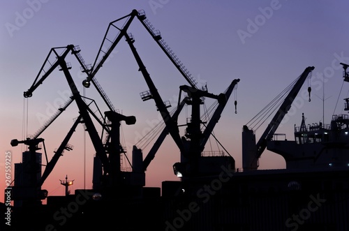 Silhouette of port cranes in the evening. port cranes at sunset