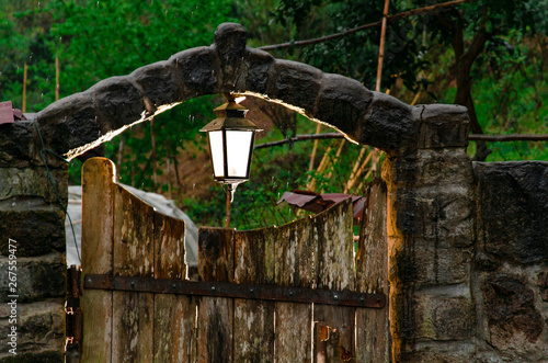 rustic door with a lantern. light behind the door