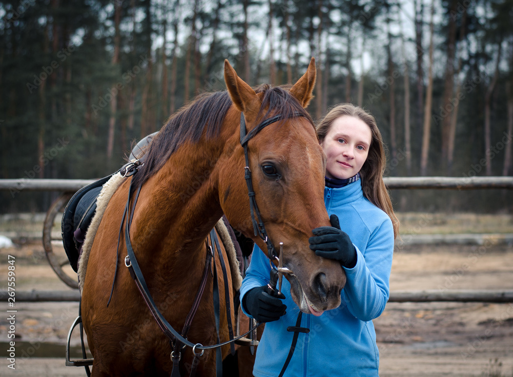 portrait of young woman with red don mare horse