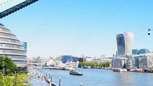 High angle slow motion point of view pov driving car or bus on Tower bridge road, Potters field park, City Hall, cityscape skyline of business skyscrapers, Thames river in London, United Kingdom photo