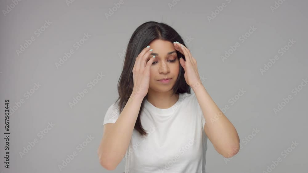 young mixed race woman in studio touches her stright shiny hair young mixed race woman in studio touches her stright shiny hair