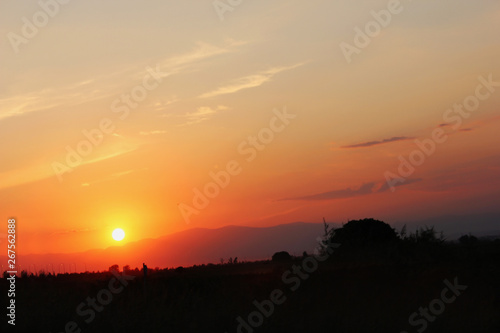 Amazing sunset sunrise with sun over mountain © Christos