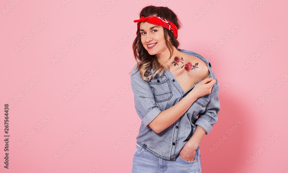 Portrait of a stylish girl in denim clothes on a pink background Portrait of a stylish girl in denim clothes on a pink background