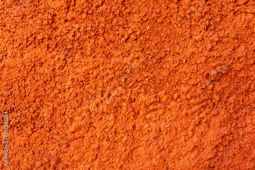 Wall of orange color in decorative plaster. Texture. Background.
