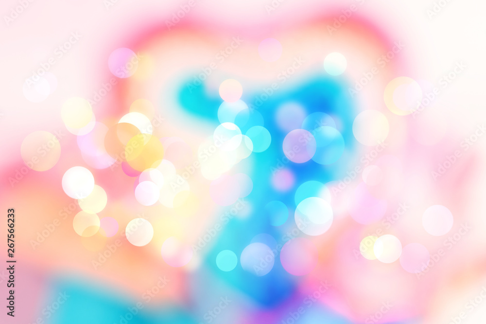 Abstract colorful blurred background with sparkling light bokeh and heart shape. Festive backdrop