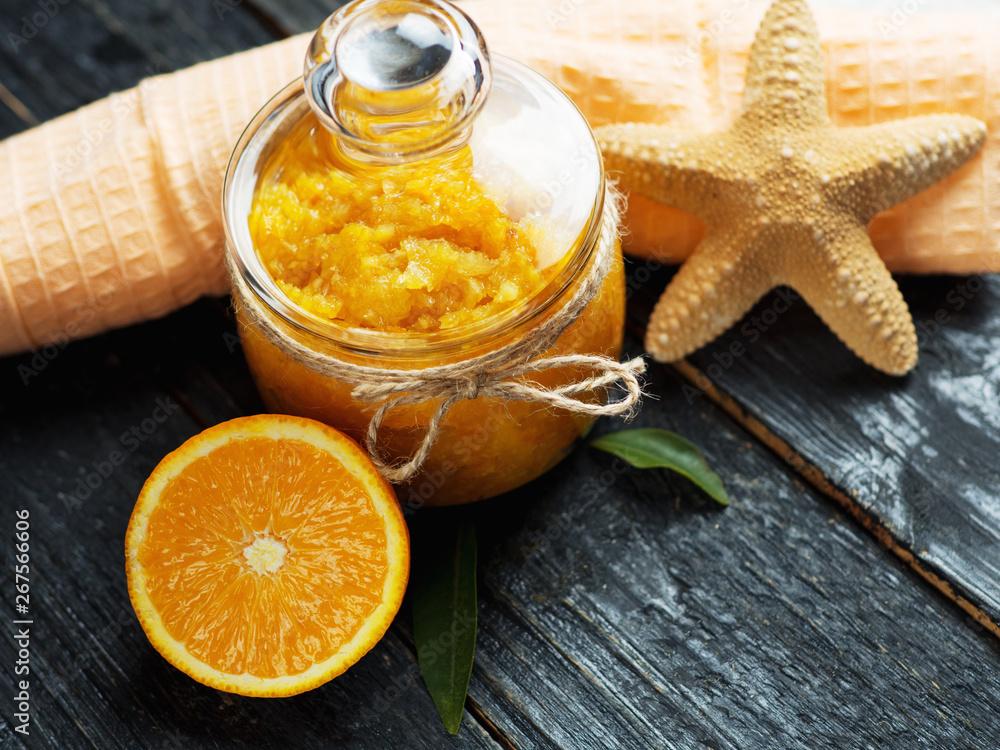 Orange skin scrub sea salt on wooden table Orange skin scrub sea salt on wooden table