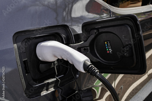 Grey electric car charging battery, close view © Martin