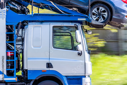 transporter truck loaded with cars on uk motorway in fast motion