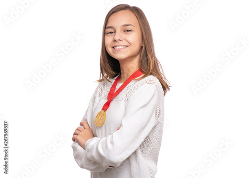 Happy winner. Portrait of beautiful Teen Girl Student with gold Medal. Smiling Child celebrating her success, isolated on white background. Back to School concept.