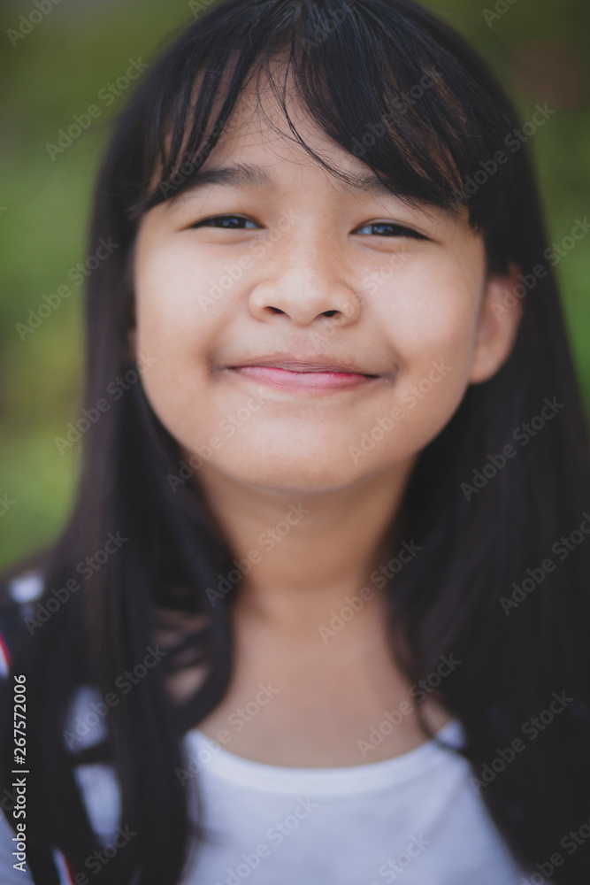 headshot shallow depth of field of asian teenager smiling face headshot shallow depth of field of asian teenager smiling face