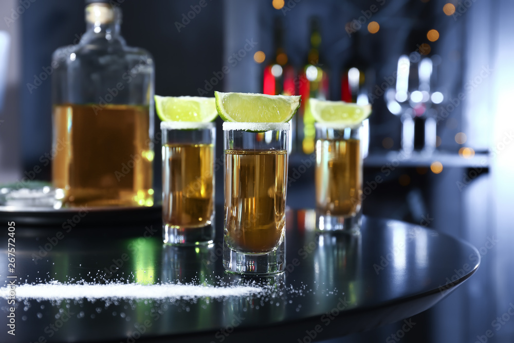 Shots of tequila on table in bar Shots of tequila on table in bar