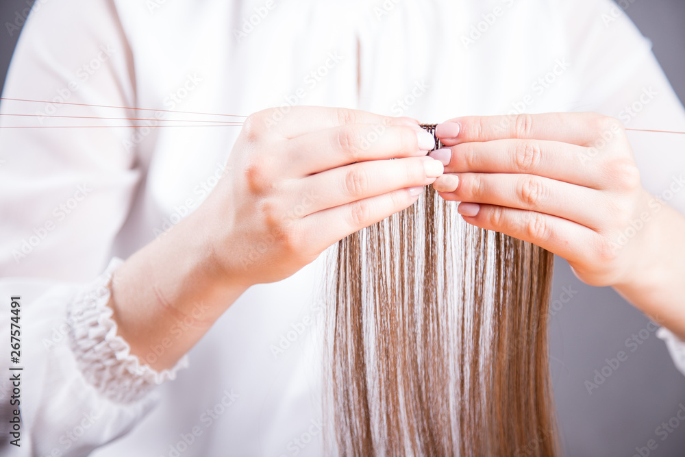 Fototapeta premium Tkanie peruki. Dłonie perukarki. 