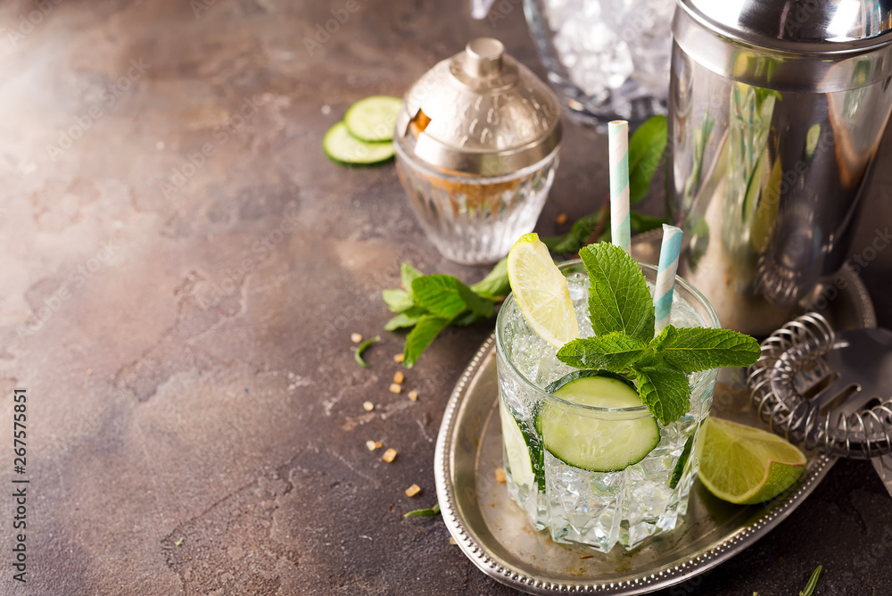 Detox infused cucumber water. Refreshing summer homemade cocktail on stone background Detox infused cucumber water. Refreshing summer homemade cocktail on stone background