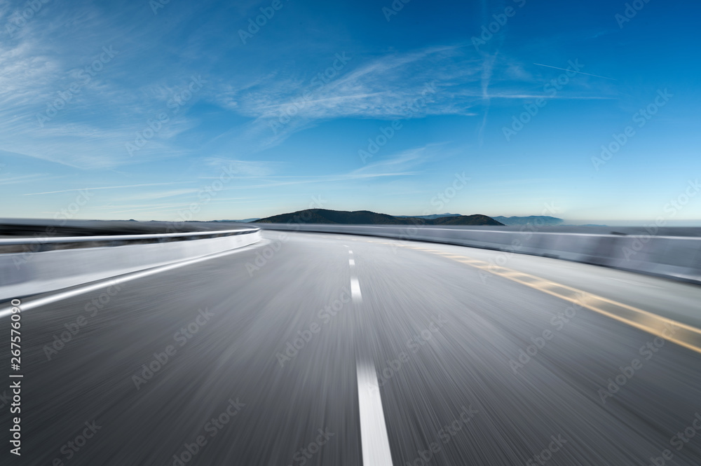 Naklejka premium Motion-blurred highway in dusk clouds