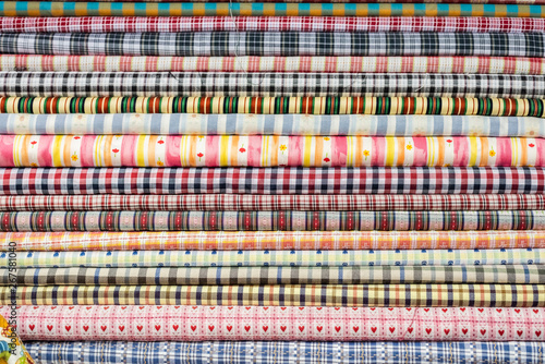 background of colorful fabric stacks