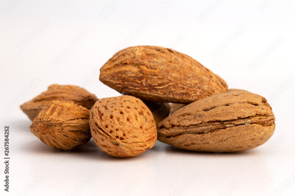 Raw almonds in shell isolated on white bacground Raw almonds in shell isolated on white bacground