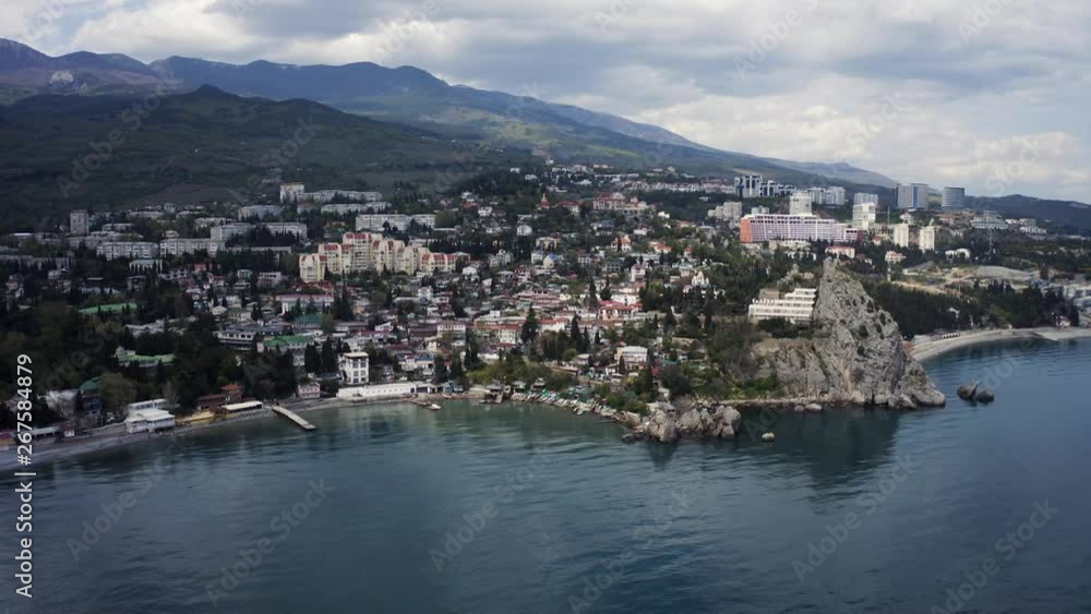 Aerial sidewards dolly, Meraba seen from the seaside, small town built on a hill near the sea on the Crimea. Aerial sidewards dolly, Meraba seen from the seaside, small town built on a hill near the sea on the Crimea.