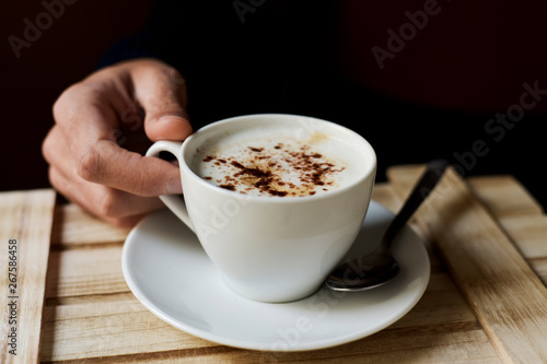 young man with a cup of cappuccino