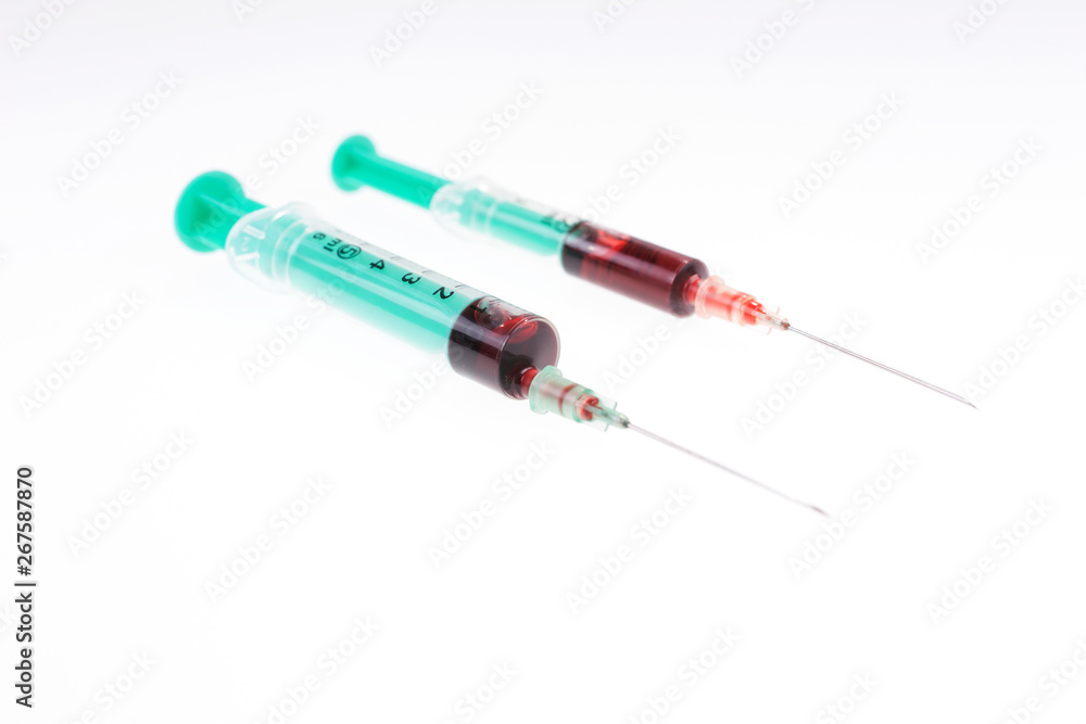 Two syringes with blood. Concept of blood donor day Two syringes with blood. Concept of blood donor day