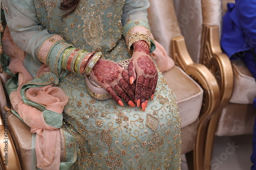 Bride hands with mehndi hina on wedding day. Beautiful hands with beautiful hina design. Indian Bride hands. Beautiful bride hands picture. photo