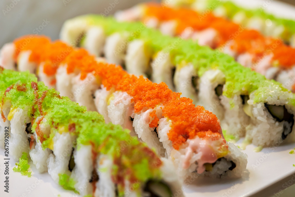 Sushi rolls with tobiko on top Sushi rolls with tobiko on top