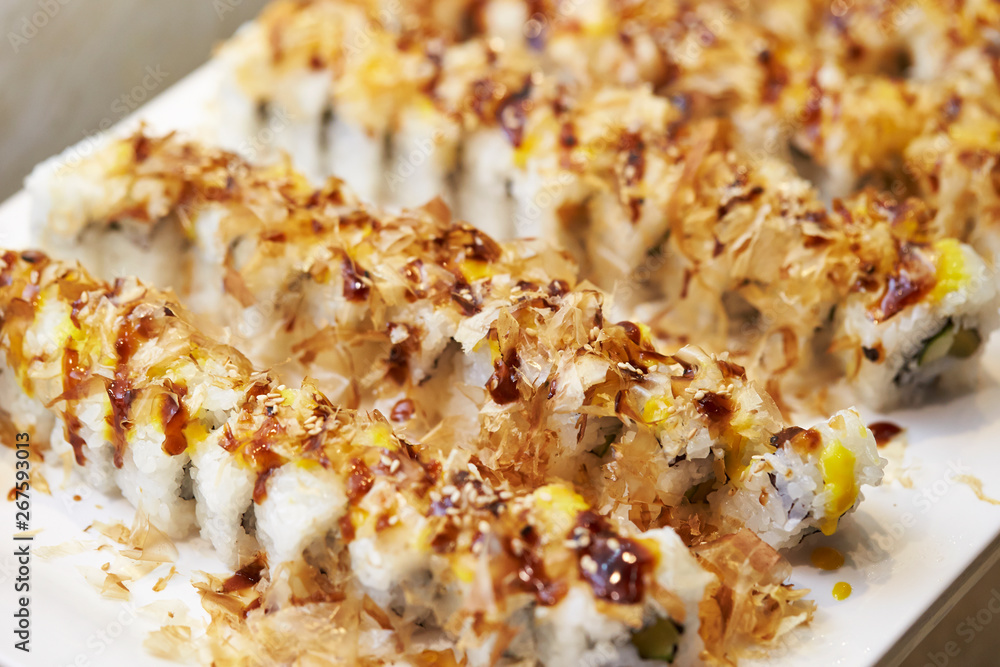 Sushi roll with bonito flakes and sauce Sushi roll with bonito flakes and sauce