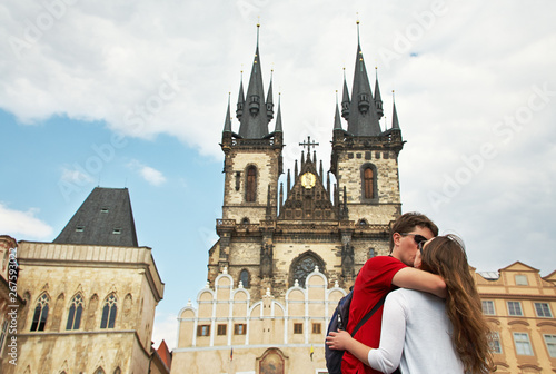 young couple travelers in love walking on a street of European city. sightseeing in Prague, Old Town Square.