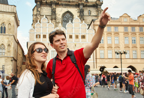 young couple travelers walking on a street of European city. sightseeing traveler. Prague, Old Town Square.